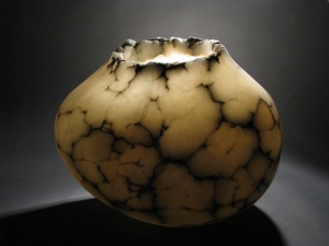 Large Alabaster stone bowl by artist Paul Hawkins illuminates a large room at night